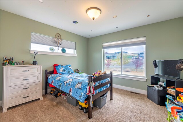 bedroom featuring light carpet