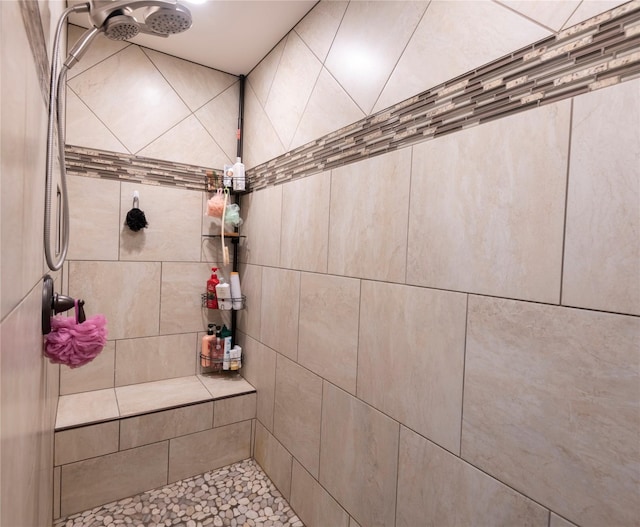 bathroom with tiled shower