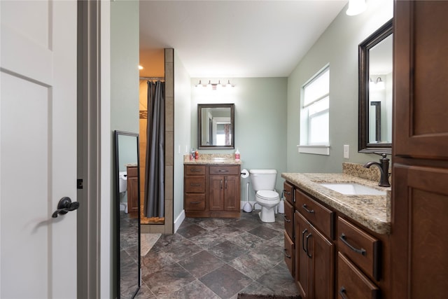 bathroom with vanity, a shower with curtain, and toilet