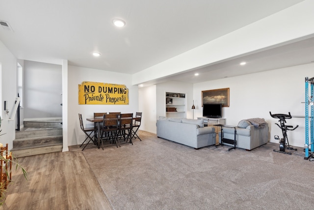 carpeted living room with built in features