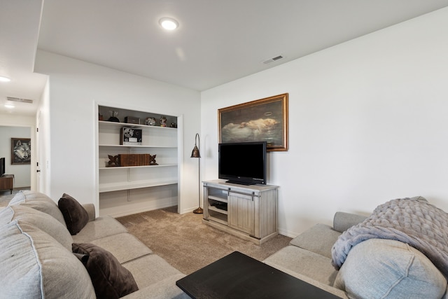 carpeted living room featuring built in shelves