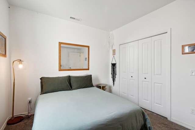 bedroom featuring dark carpet and a closet