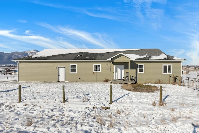 snow covered property with a mountain view