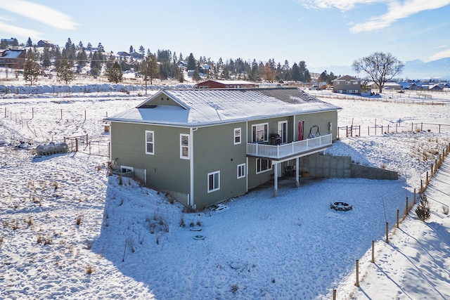 view of snow covered back of property