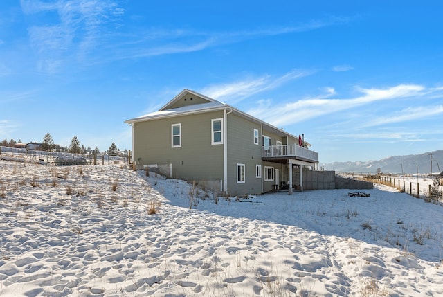 snow covered house featuring a mountain view