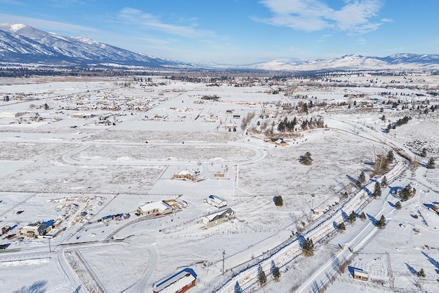 snowy aerial view with a mountain view