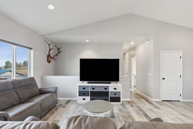 living room with vaulted ceiling and light hardwood / wood-style floors