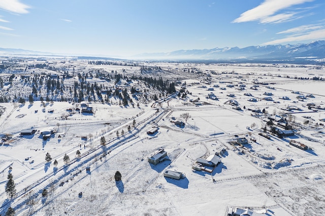 snowy aerial view with a mountain view