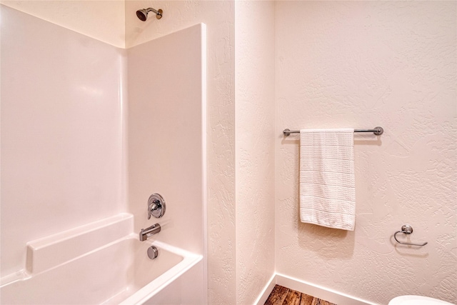 bathroom featuring hardwood / wood-style flooring and shower / bathing tub combination