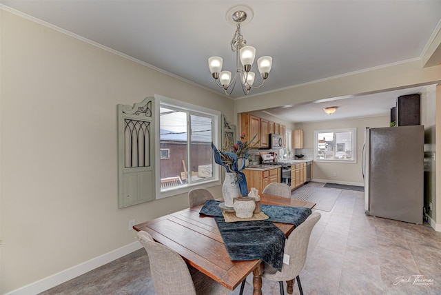 dining room with ornamental molding and a chandelier