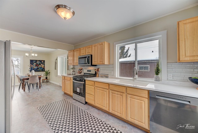 kitchen featuring pendant lighting, sink, stainless steel appliances, decorative backsplash, and light brown cabinets