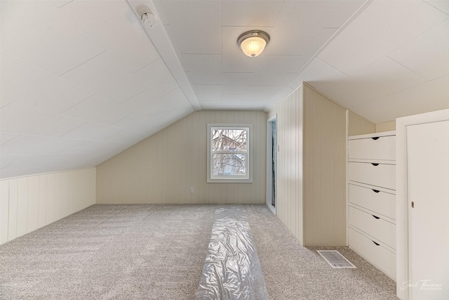 bonus room featuring light colored carpet and lofted ceiling