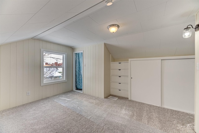 bonus room with carpet floors and vaulted ceiling