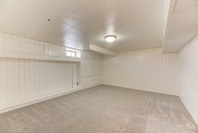 basement with wooden walls and carpet