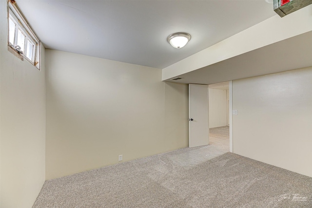 basement featuring light carpet