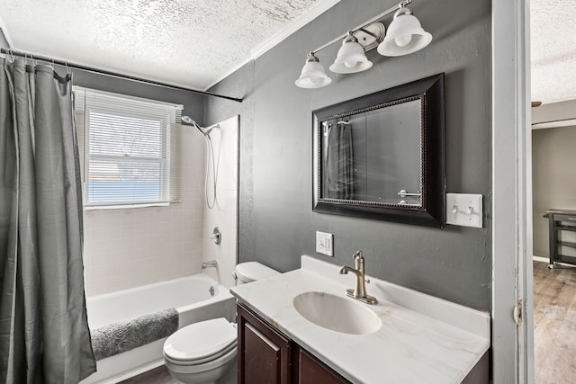 full bathroom with toilet, a textured ceiling, hardwood / wood-style flooring, vanity, and shower / bath combination with curtain