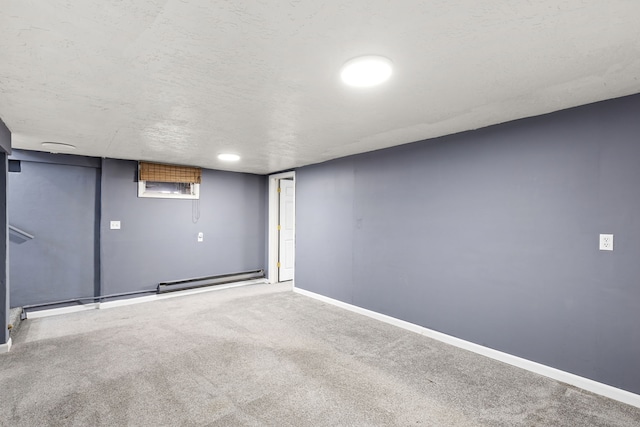 basement featuring carpet flooring and a textured ceiling