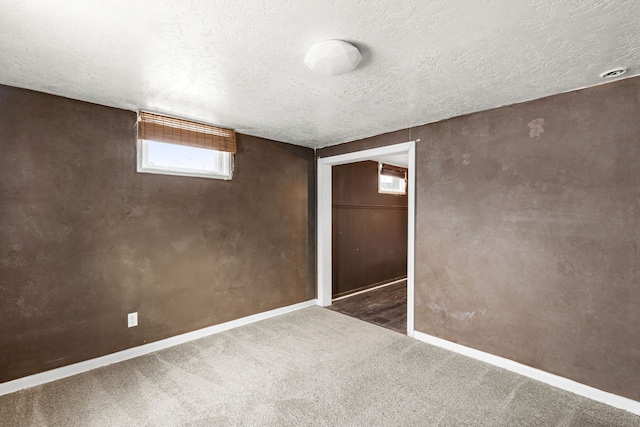 unfurnished bedroom with a textured ceiling, dark carpet, and a closet