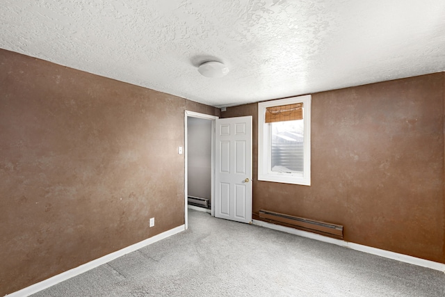 unfurnished room featuring carpet floors, a textured ceiling, and baseboard heating