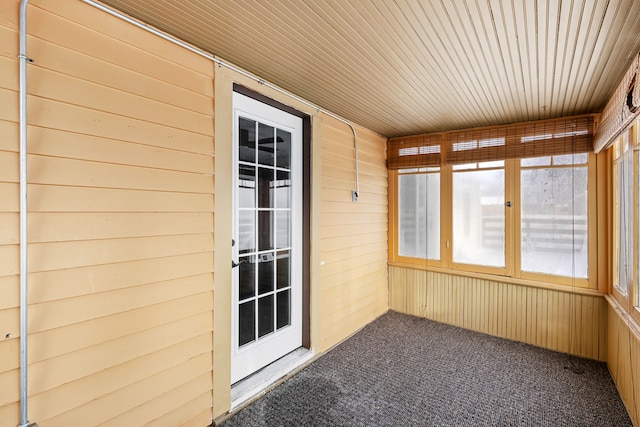 unfurnished sunroom featuring wood ceiling