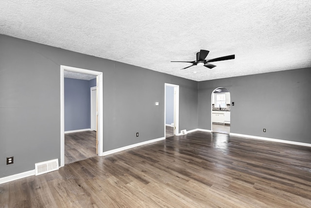 spare room with hardwood / wood-style floors, a textured ceiling, and ceiling fan