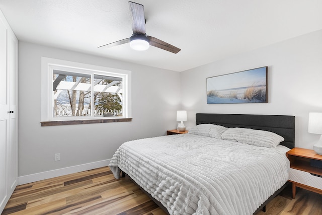 bedroom featuring hardwood / wood-style flooring and ceiling fan