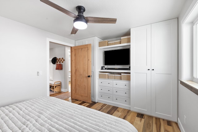 bedroom featuring ceiling fan and light hardwood / wood-style flooring