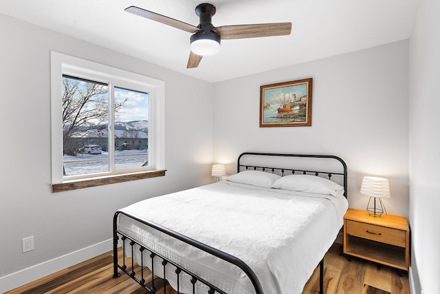 bedroom featuring ceiling fan and dark hardwood / wood-style flooring