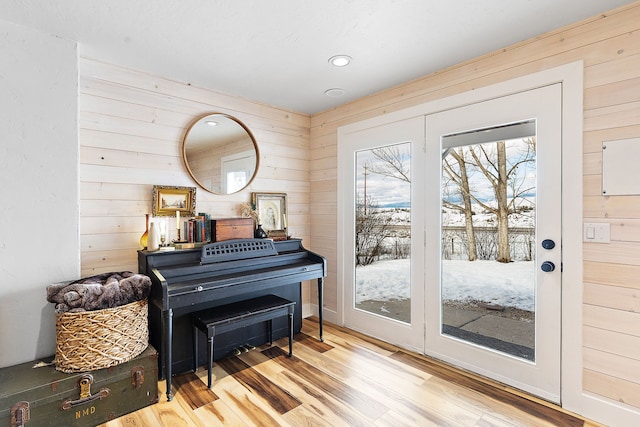 misc room with hardwood / wood-style flooring and wood walls