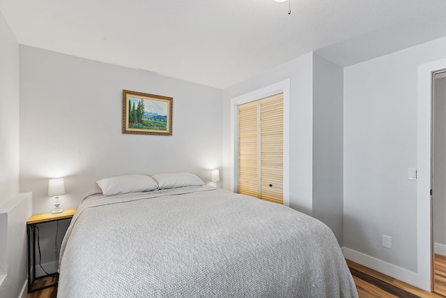 bedroom featuring hardwood / wood-style floors and a closet