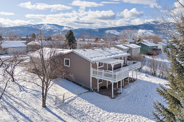 snowy aerial view with a mountain view