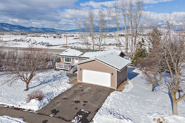 snowy aerial view featuring a mountain view