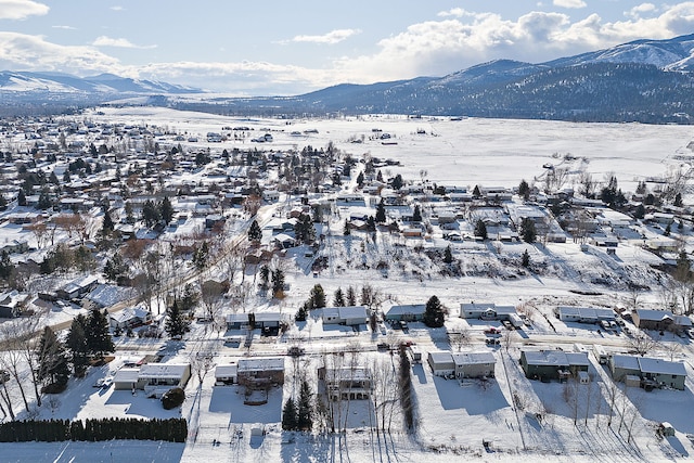 snowy aerial view with a mountain view