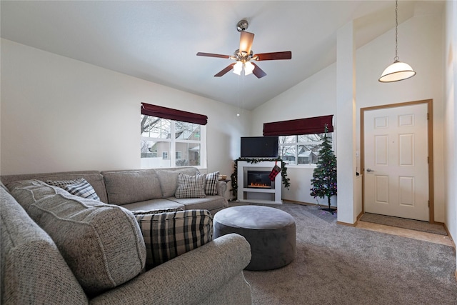 carpeted living room with high vaulted ceiling and ceiling fan