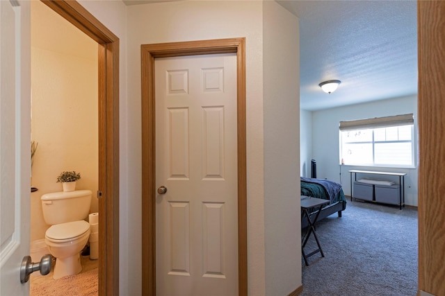 bathroom featuring a textured ceiling and toilet