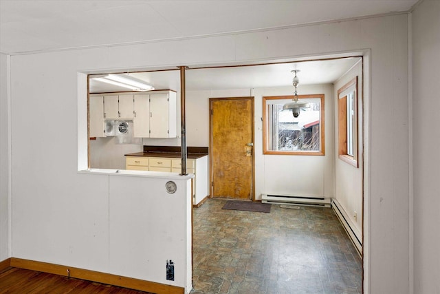 kitchen featuring white cabinetry, hanging light fixtures, and a baseboard radiator