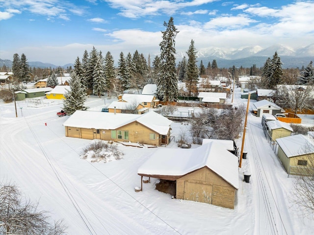 snowy aerial view with a mountain view