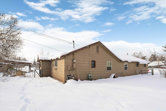 view of snow covered rear of property