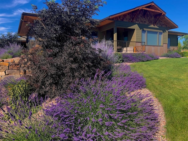 view of side of home with a yard