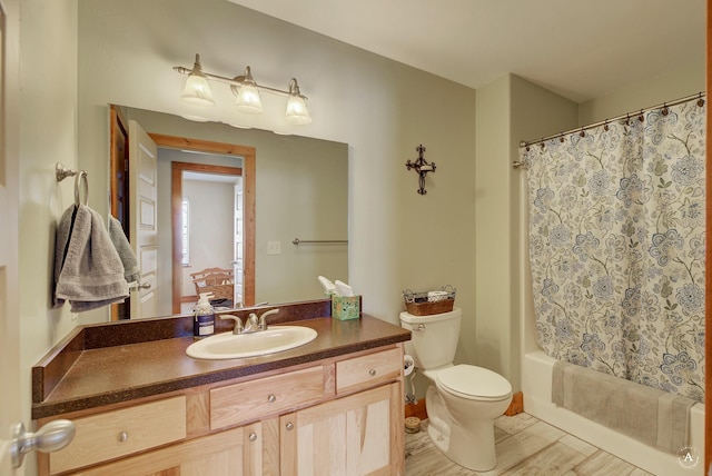 full bathroom featuring vanity, wood-type flooring, shower / bathtub combination with curtain, and toilet