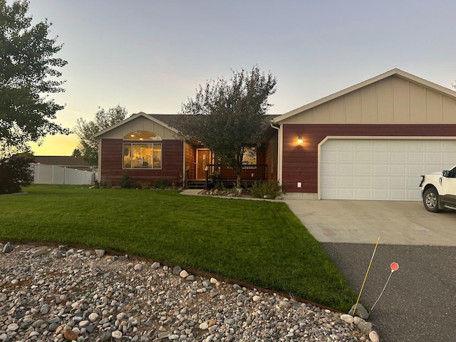 single story home with a yard and a garage