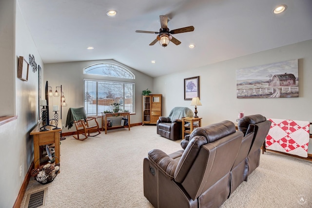 living room with ceiling fan, lofted ceiling, and carpet