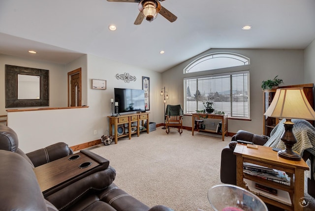 living room featuring carpet floors, ceiling fan, and vaulted ceiling