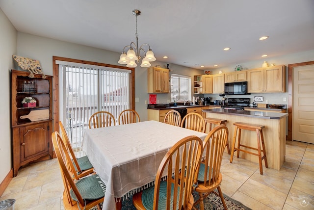 dining area featuring a chandelier and sink