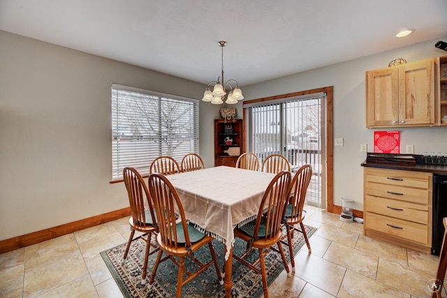 tiled dining area featuring a notable chandelier