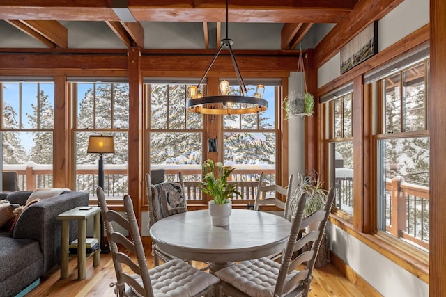 dining space with an inviting chandelier and light hardwood / wood-style flooring