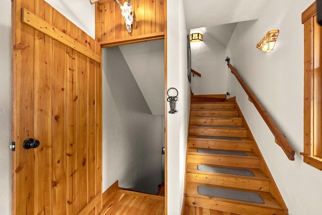 stairs featuring wood-type flooring