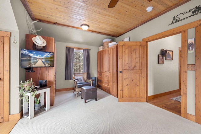 sitting room with lofted ceiling, carpet floors, wooden ceiling, and ceiling fan