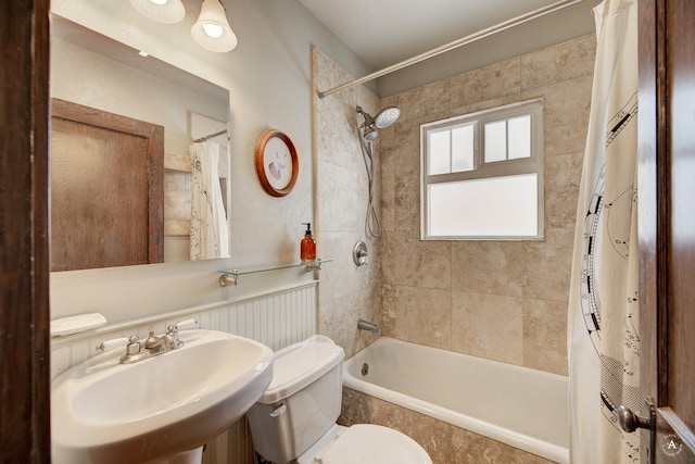 full bathroom featuring sink, shower / tub combo, and toilet