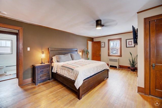 bedroom with crown molding, radiator heating unit, ceiling fan, and light hardwood / wood-style floors